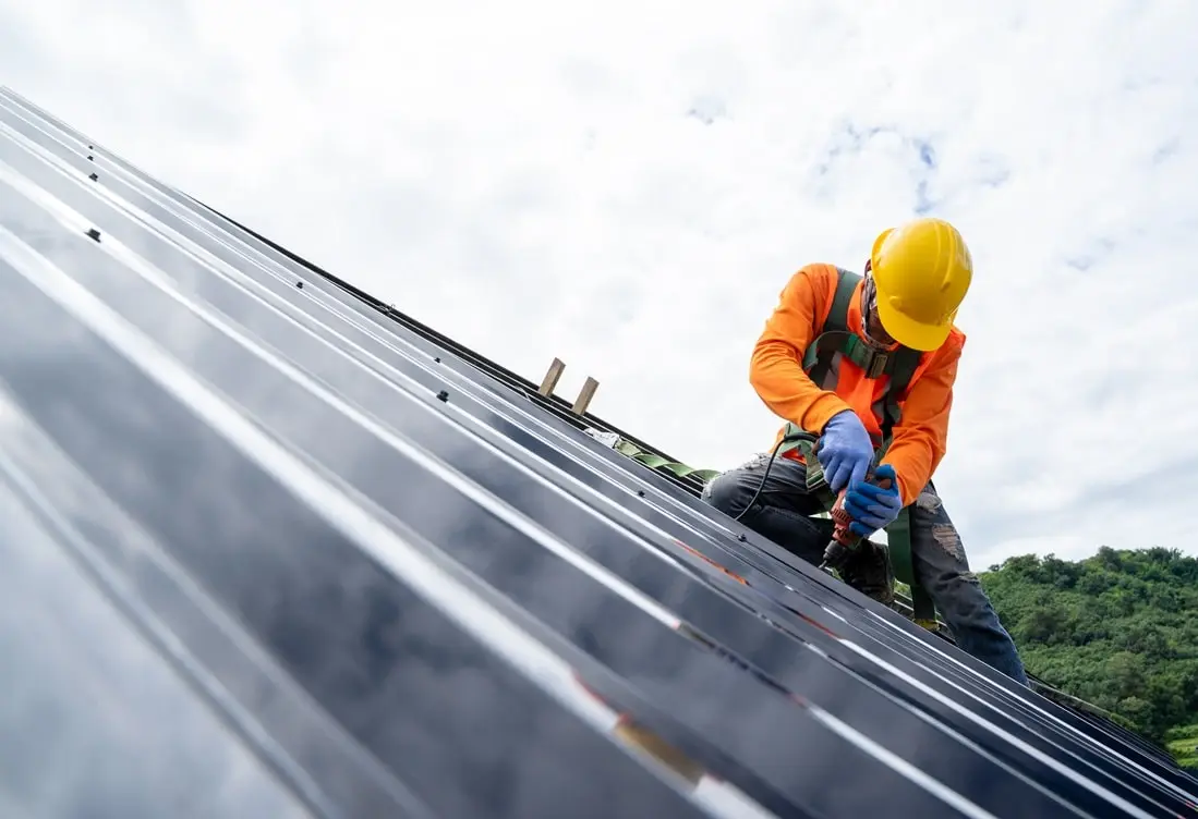 A man working on a metal roof